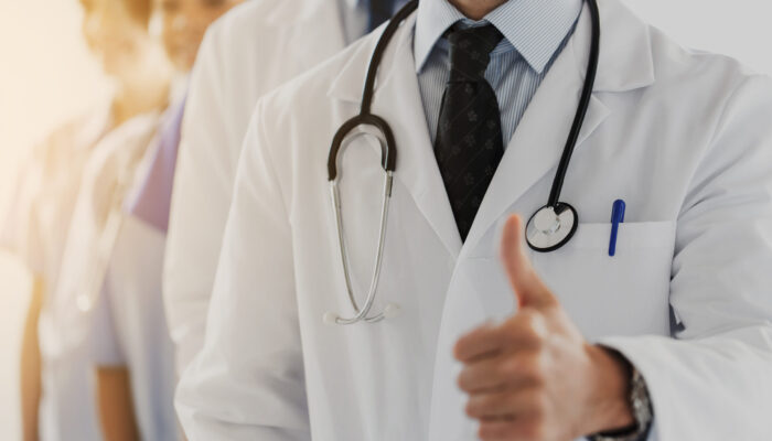 gesture, health care, people and medicine concept - close up of happy doctor showing thumbs up